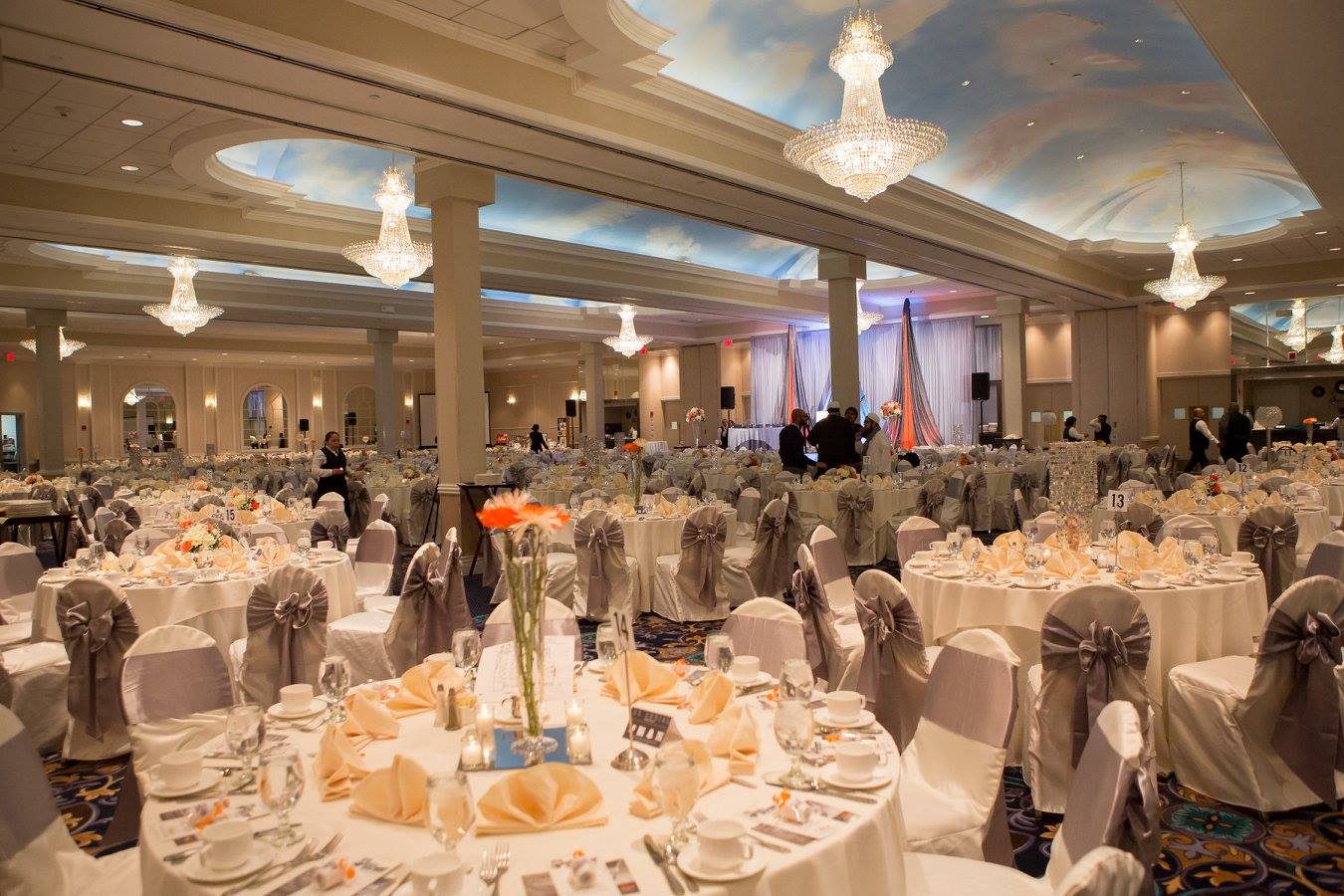 empty banquet hall with white tables and chairs