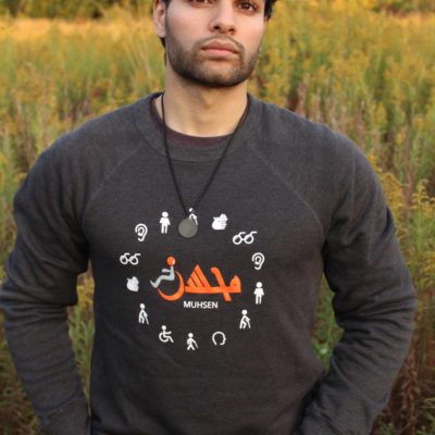 Man wearing Muhsen crewneck standing in a field.